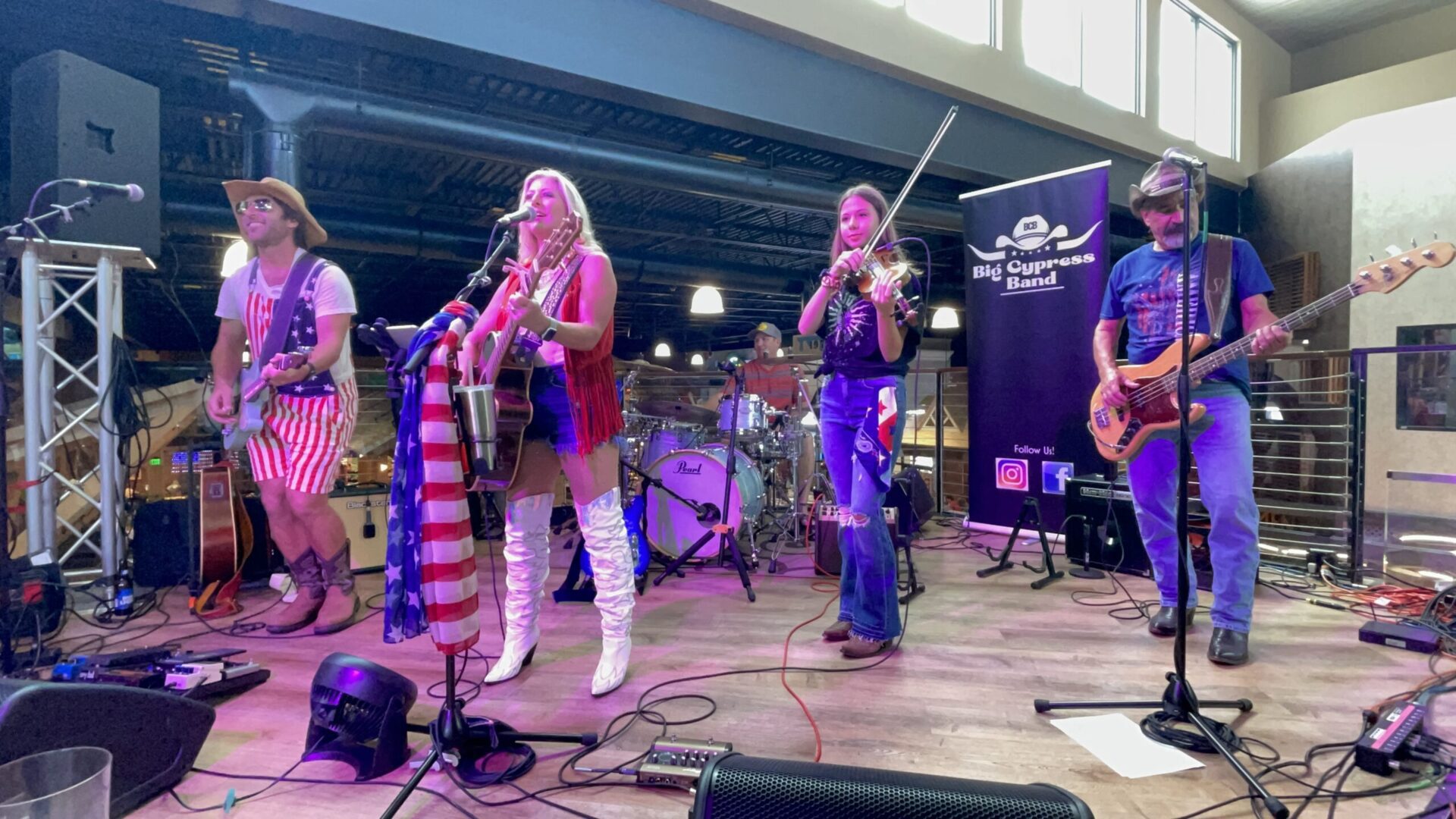 A group of people playing instruments on stage.