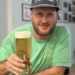 Smiling man holding a pint of beer