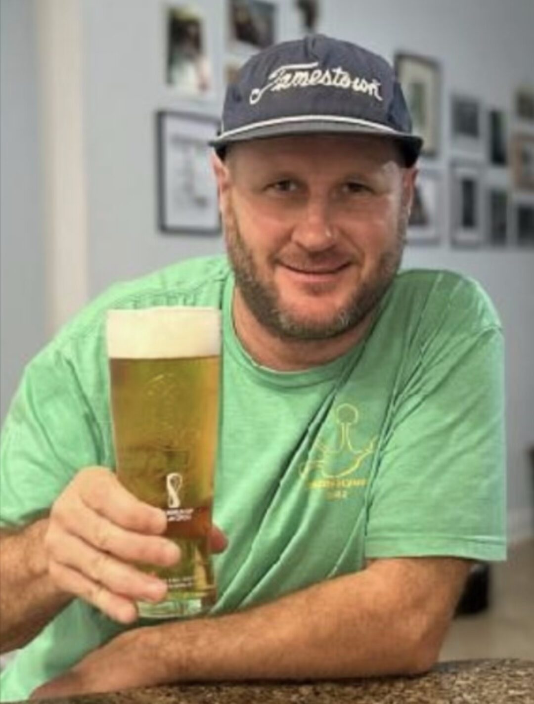 Smiling man holding a pint of beer